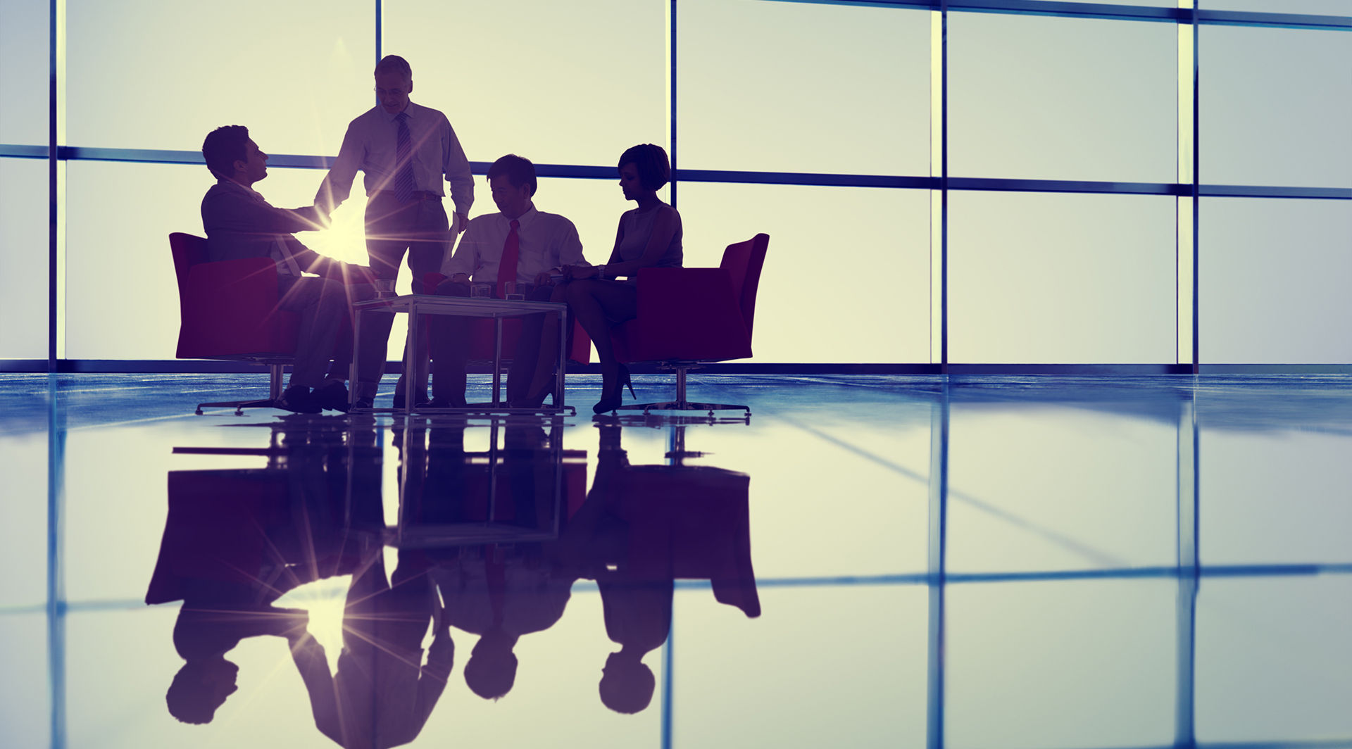 Insurance executives discussing regulatory strategy in a sunlit boardroom